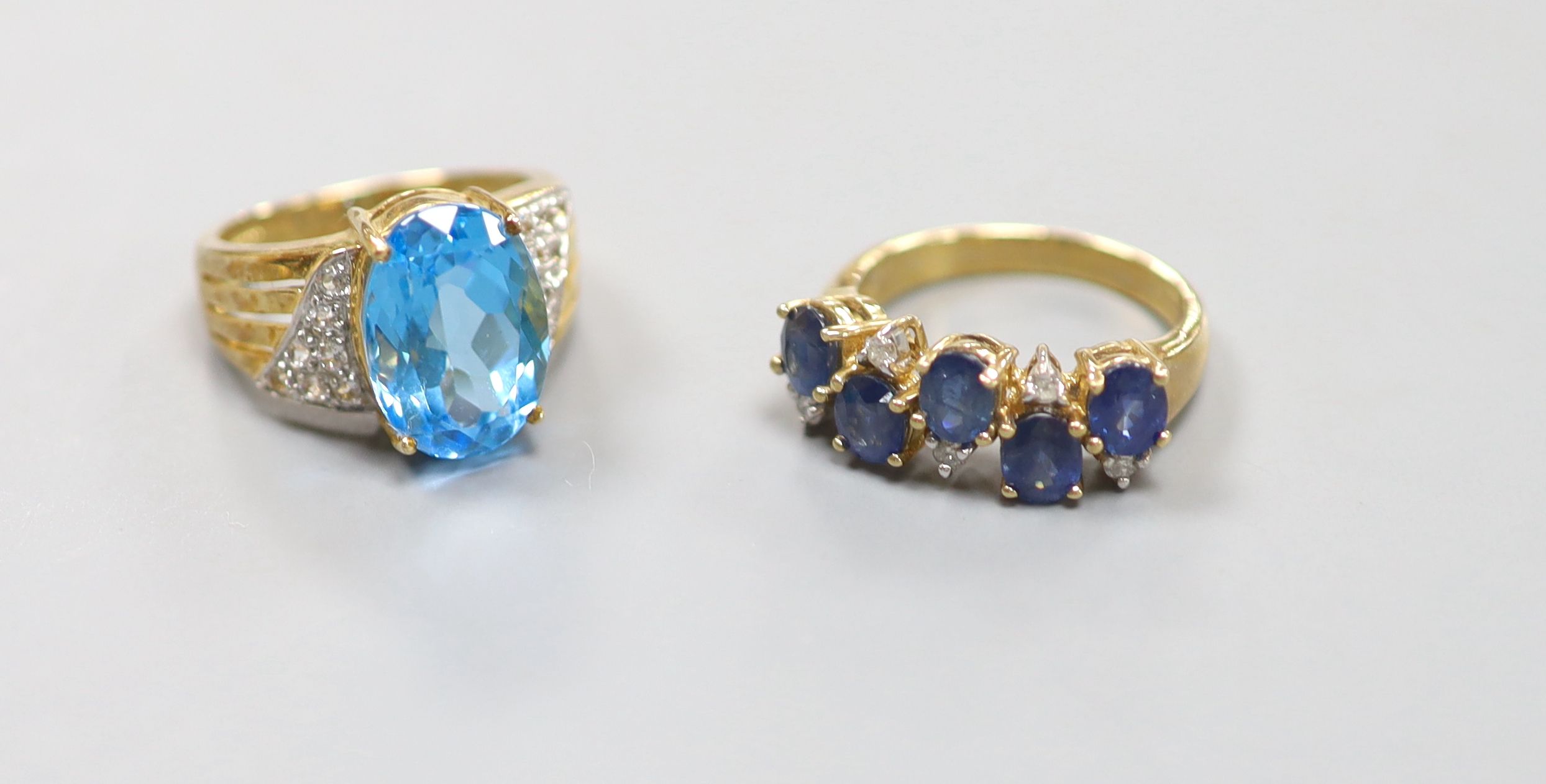 A sapphire and diamond double line ring, 9ct gold shank and another 9ct gold ring set blue and white topaz